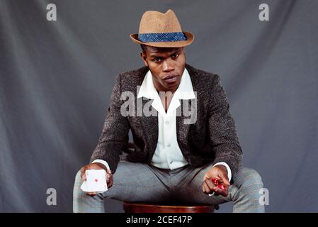 man with playing card throwing dices Stock Photo