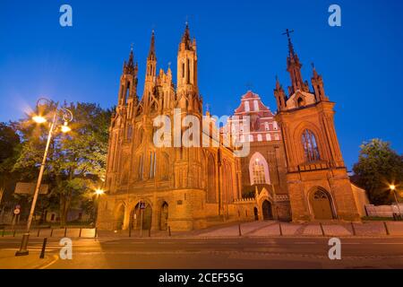 Night view of illuminated Gothic style St. Anne Church at Maironio Street in the Old Town of Vilnius, Lithuania. Church of St. Francis and St. Bernard Stock Photo