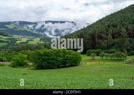 Green landscape, villages surrounded by fields and trees and mountains in south tyrol, south tyrol. Dolomites, Italy. Tourist accommodations and lodge Stock Photo