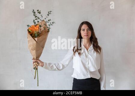 Young Woman holding a bouquet of flowers Stock Photo