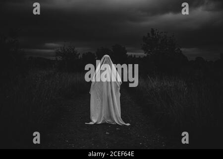 person disguised as a ghost on the road Stock Photo