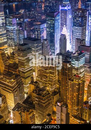 Aerial view of a modern glass high-rise building reflecting the sky and ...