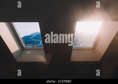 View of mountains through mansard window Stock Photo