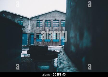 View of abandoned storehouse with broken windows in cold day Stock Photo