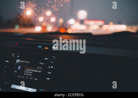 Inside shot of car panel with tablet display on background of lights in night Stock Photo