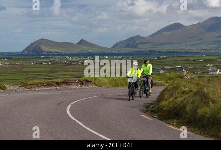 Dingle Peninsula, Ireland - 29th August 2020: Tourists cycling scenic Slea Head Drive on the Dingle peninsula, county Kerry on the west coast of the R Stock Photo