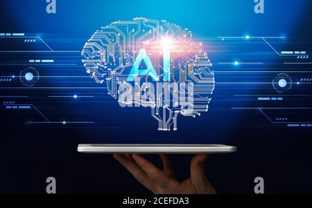 Hand holding digital tablet with human brain proection Stock Photo