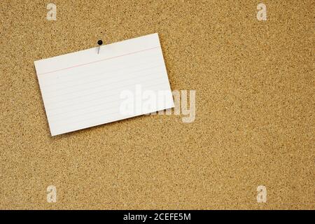 sticky note card pinned to cork board Stock Photo