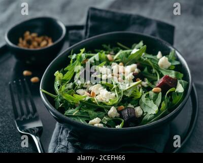 Beetroot, aragula and soft cheese salad over gray linen tablecloth. Stock Photo