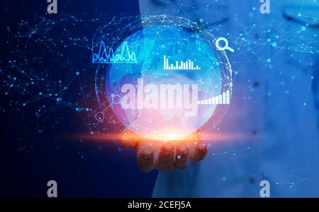 Global Business Technologies. Female Holding Globe Hologram With Polygonal Connections And Charts Stock Photo