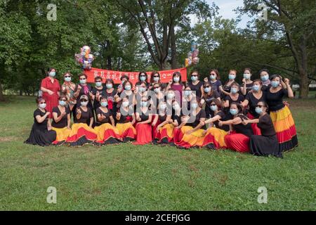 Posed group portrait of Chinese American dancers from the Wenzhou America New York troupe at their 5th anniversary performance in a park in New York. Stock Photo