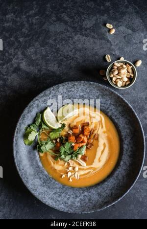 Thai pumpkin soup with limes and peanuts Stock Photo