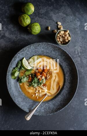 Thai pumpkin soup with limes and peanuts Stock Photo