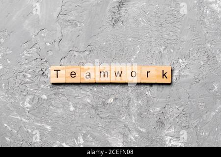 TEAMWORK word written on wood block. TEAMWORK text on cement table for your desing, concept. Stock Photo