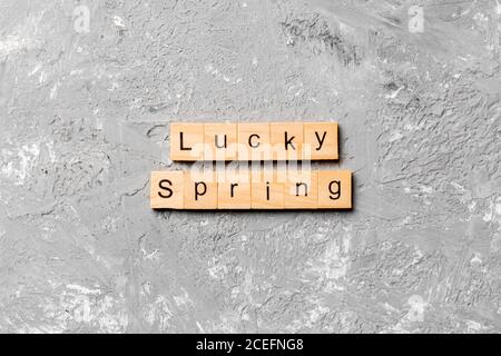 lucky Spring word written on wood block. lucky Spring text on cement table for your desing, concept. Stock Photo