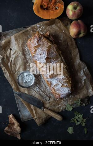 Knife near pumpkin and apple strudel Stock Photo