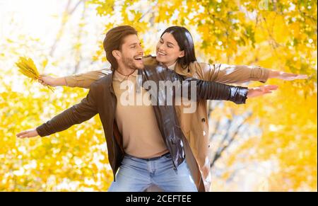 Carefree lovers having fun in autumn forest Stock Photo