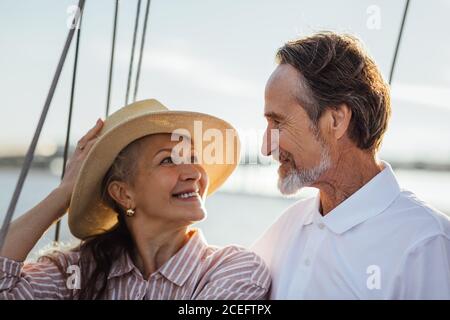 Affectionate couple on a boat trip looking to each other at sunset Stock Photo