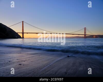 United States of America, California, Golden Gate Bridge. The iconic Golden Gate Bridge in San Francisco viewed from Kirby Cove at dawn.