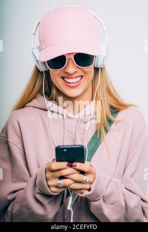 Woman excited smiling listening to music radio in bluetooth headphones ...