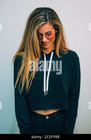 Young Woman with sunglasses posing in studio Stock Photo