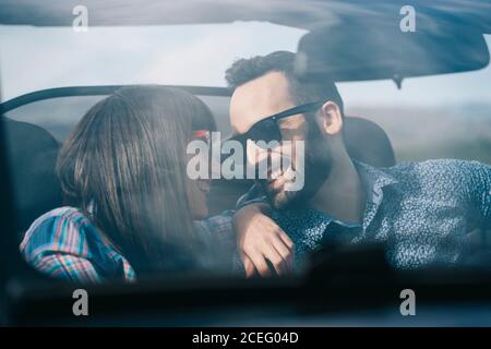 man and Woman travel in convertible car. Stock Photo