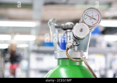 Gas cylinders with pressure gauge in a specialized laboratory. Laboratory material. Stock Photo