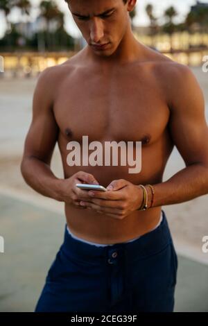 Athlete man training outdoors with mobile. Stock Photo