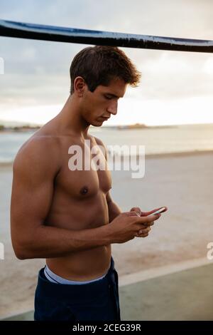 Athlete man training outdoors with mobile. Stock Photo