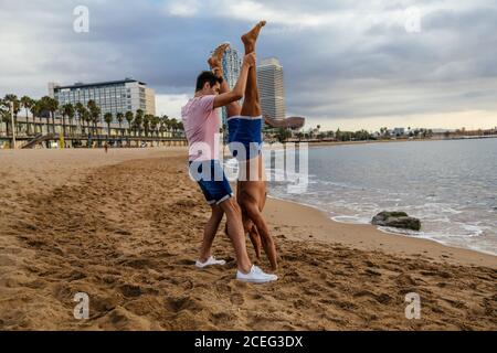Two athletes do a handstand on the beach. Stock Photo