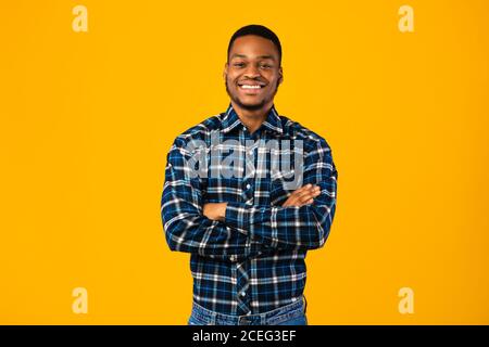 Black Man Posing Crossing Hands Standing In Studio Stock Photo