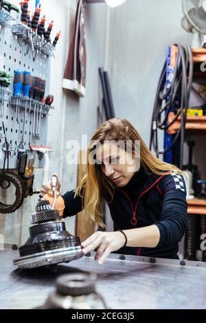 Woman working in a mechanical workshop Stock Photo