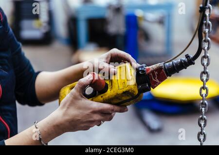 Woman with tools in a mechanical garage Stock Photo