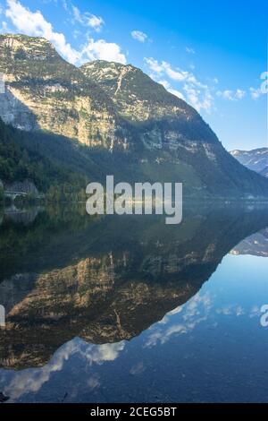 Mirror reflection in Hallstatter See,Austria. Summer spring colors lake and mountain in the background at sunrise in Austrian Alps.Beautiful peaceful Stock Photo