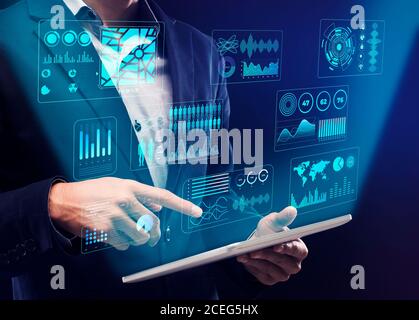 Businessman using digital tablet with interactive board Stock Photo