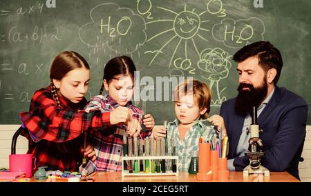 Life under microscope. happy children teacher. back to school. experimenting with chemicals or microscope at laboratory. biology education. Microscope Stock Photo