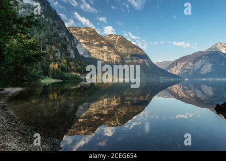 Mirror reflection in Hallstatter See,Austria. Summer spring colors lake and mountain at sunrise in Austrian Alps.Beautiful peaceful nature scenery,tur Stock Photo