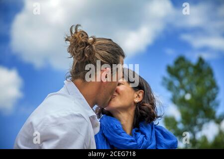 Low angle shot of a happy young couple kissing Stock Photo