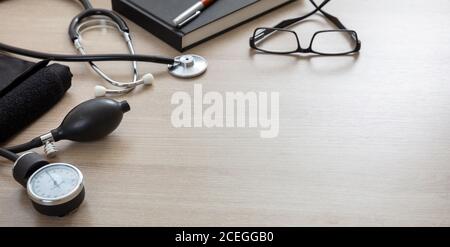 Blood pressure measure equipment, Hypertension control. Medical stethoscope and sphygmomanometer on doctor office desk, closeup view. Stock Photo