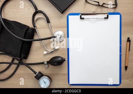 Medical stethoscope and sphygmomanometer on cardiologist doctor office desk. Blood pressure measure equipment, Hypertension control. Stock Photo