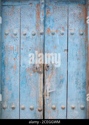 Close-up of texture old door with weathered wooden surface in metal rusty rivets, Uzbekistan Stock Photo