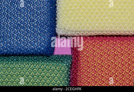 Colorful cleaning sponges placed in corners, full frame macro image. Focus on geometric shapes. Stock Photo