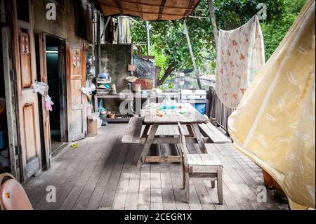 The veranda of a traditional Thai house overlooking one of the canals known as khlongs in central Bangkok Thailand. Stock Photo