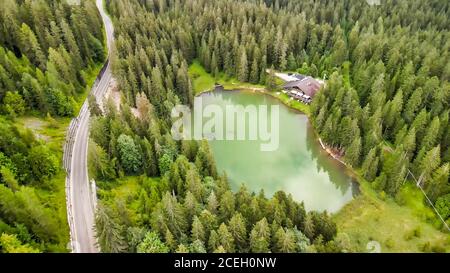 Beautiful Chalet in the middle of the forest, along a lake border. Stock Photo