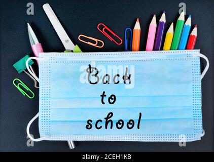Back to school words on face mask. Top view Stock Photo