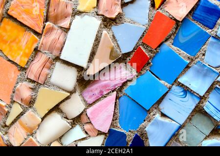 Mosaic of broken multicolored small tiles tiles as background. Stock Photo