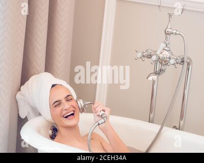 Laughing young Woman having bath Stock Photo