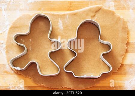 Cooking and decorating christmas gingerbread. Gingerbread man mould. Gingerbread man and his wife. Gingerbread in the shape of a stylized human and ot Stock Photo