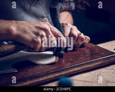 Crop craftsman working with hammer Stock Photo
