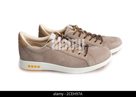 Men's beige nubuck leather sneakers isolated on white background, leather lace, fabric lining and light platform soles for maximum comfort Stock Photo